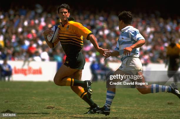 David Wilson of Australia beats a defender during the Hong Kong Rugby Sevens match against Argentina in Hong Kong. \ Mandatory Credit: David...