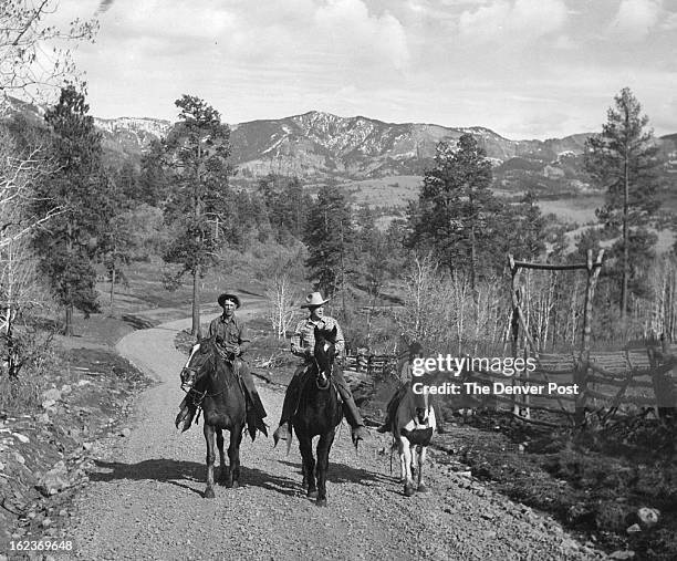 Riding up the road to the Red Ryder Ranch near Pagosa springs, Colo., are Floyd Bramwell, ranch foreman; Fred Harman, creator of Red Ryder, and...