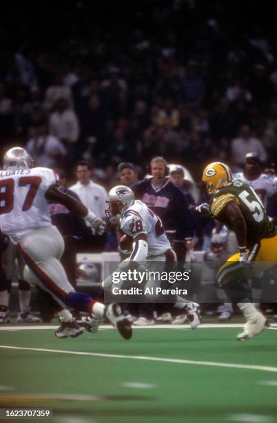 Running Back Curtis Martin of the New England Patriots has a short gain in the Super Bowl XXXI game between the Green Bay Packers v the New England...