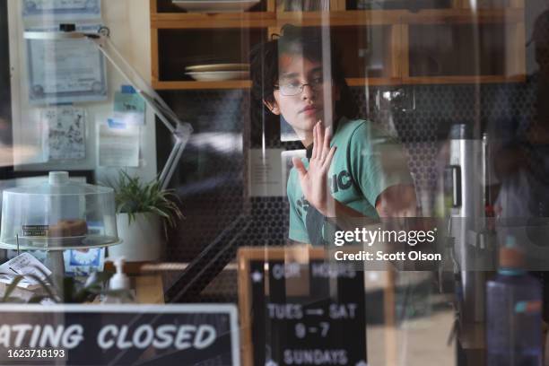 Eden Austin waits on customers at the Same Day Cafe in the Logan Square neighborhood on August 18, 2023 in Chicago, Illinois. The city of Chicago is...