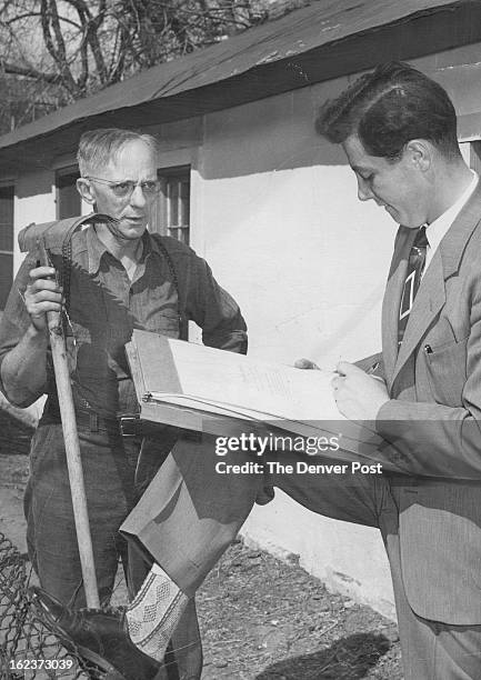 Harry Tillman patiently answers questions put to him by Fred Straface of 5152 Washington street as the U. S. Census force took the field Saturday....