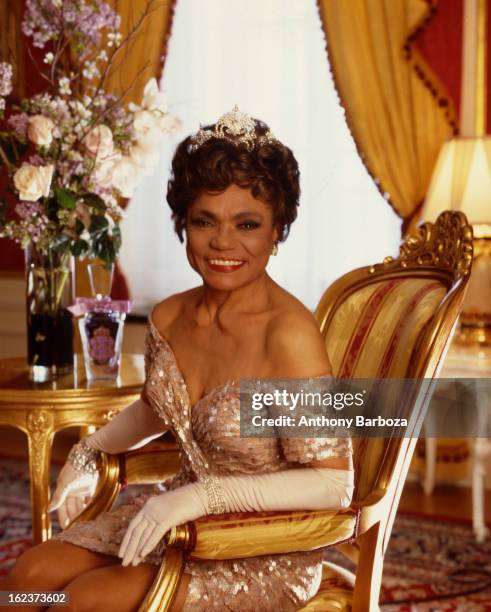 Portrait of American actress and singer Eartha Kitt as she poses in a chair in a room at the Plaza Hotel, New York, New York, 1992.