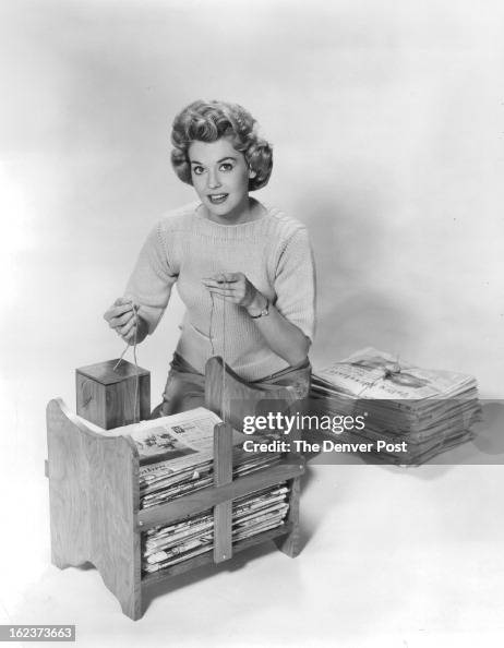 MAR 11 1962; Newspaper bundler shown here with TV actress Donna Douglas makes storage easy and order MAR 11 1962; Newspaper bundler shown here with TV actress Donna Douglas makes storage easy and order