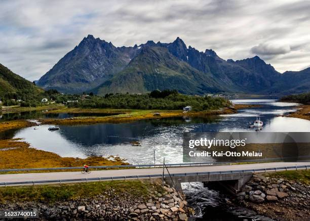 An athlete on the bike leg of The Arctic Triple - Lofoten Triathlon on August 18, 2023 in Svolvar, Norway.