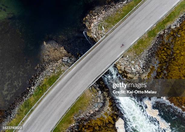 An athlete on the bike leg of The Arctic Triple - Lofoten Triathlon on August 18, 2023 in Svolvar, Norway.