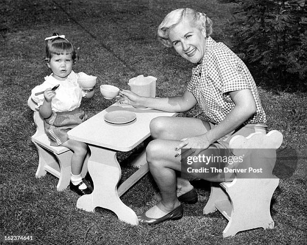 The child's table and chair set, displayed above by Songstress Margaret Whiting and her little girl, is a junior edition of a grown-up's model. It...