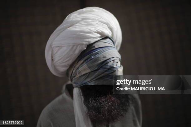 Detainee is interrogated by Afghan policemen at a US Marine base for 3rd Battalion, 6th Marines in Marjah, Helmand province, on April 7, 2010. A...