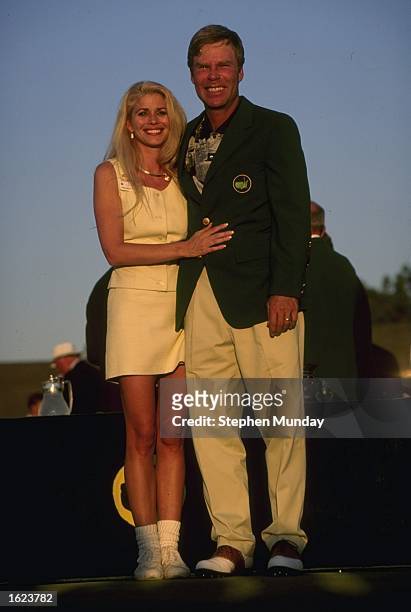 Ben Crenshaw of the USA wears the coveted green jacket and stands with his wife Julie after winning the US Masters at the Augusta National Golf Club...
