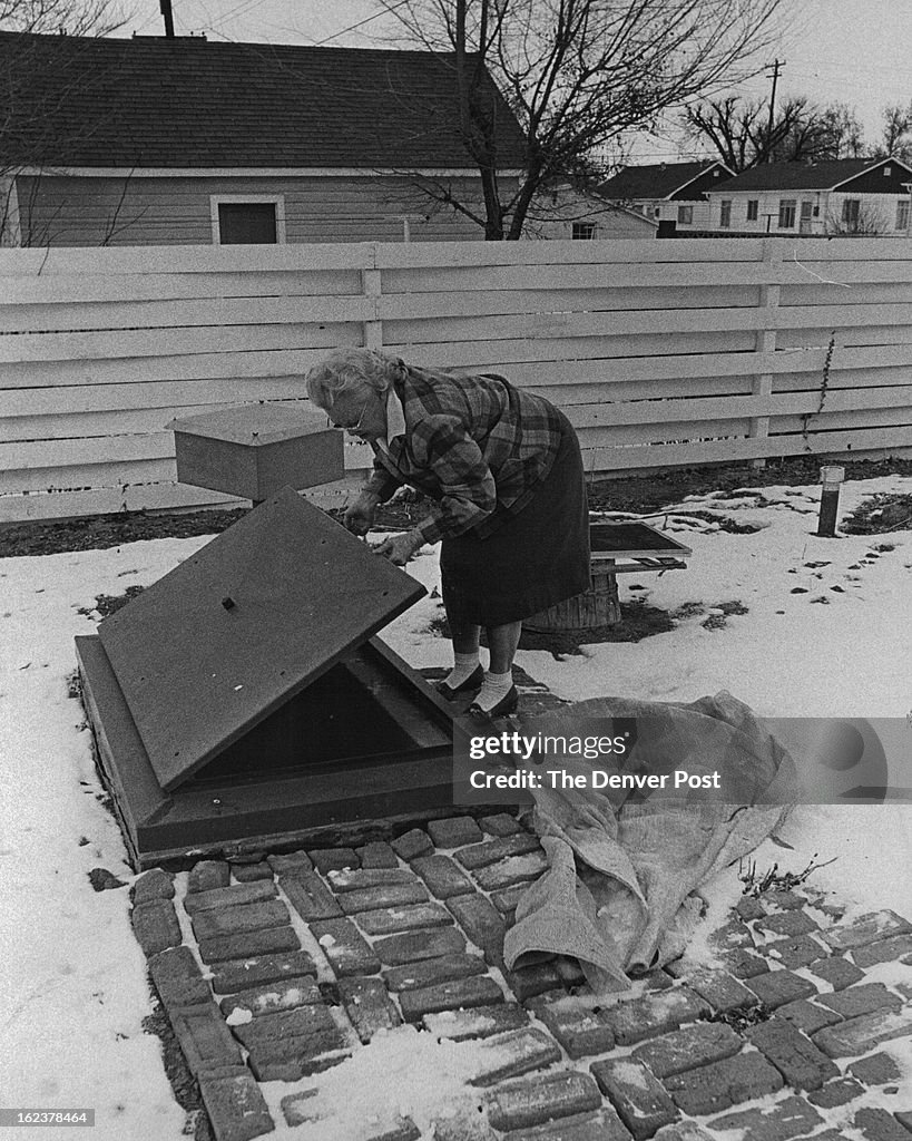 JAN 25 1963, 2-2-1963; Mrs. M. W. Marion prepares to enter her fallout shelter, located in the backy