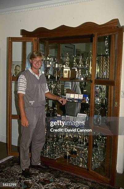 Ernie Els stands next to the trophy cabinet in his home in South Africa. \ Mandatory Credit: David Cannon/Allsport