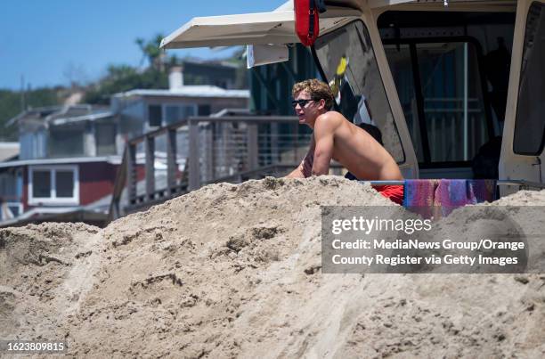 August 18: A California State Parks lifeguard keeps watch at the Crystal Cove Beach Cottages in Newport Beach, CA on Friday, August 18, 2023. A berm...