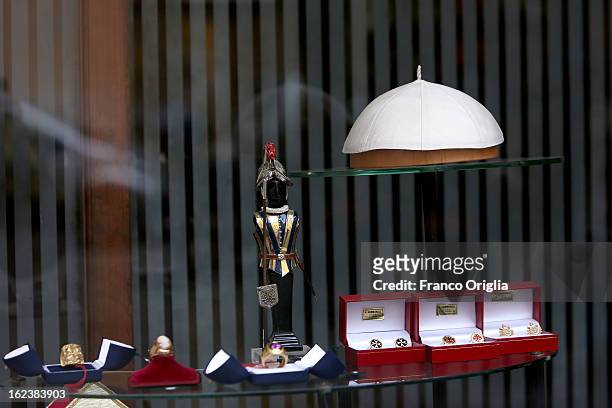 Window display showing the future Pope's skullcap, a statue representing a Swiss Guard and rings worn by Cardinals, are seen in shop of Stefano...