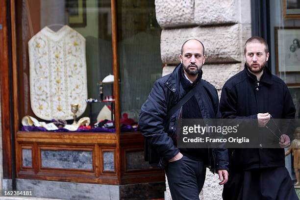 Priests walk in front of the shop of Stefano Gammarelli, the Pope's taylor on February 22, 2013 in Rome, Italy. A new Pope will be elected by the...