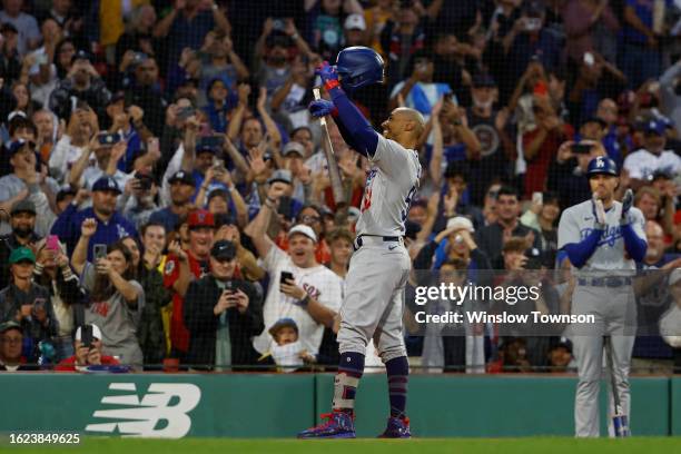 Mookie Betts of the Los Angeles Dodgers tips his hat as the fans give him a standing ovation upon his return to Fenway Park during the first inning...