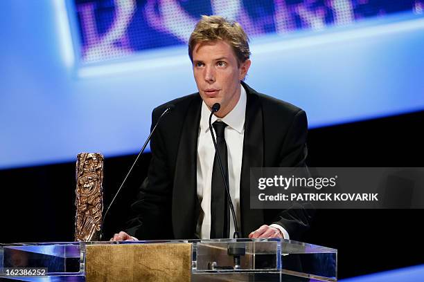 French director Nicolas Guiot speaks beside his trophy after receiving the Best Short Film award for his film "Le cri du homard" during the 38th...