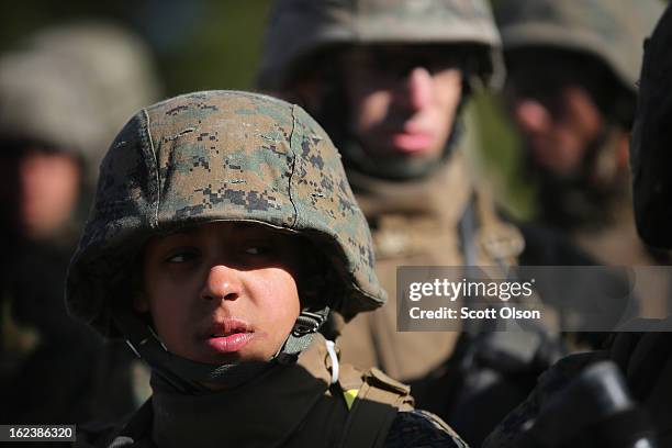 Pvt. Vanessa Crump listens to instructions before firing on the rifle range during Marine Combat Training on February 20, 2013 at Camp Lejeune, North...