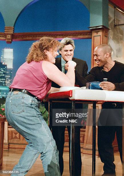 Episode 1065 -- Pictured: Athlete Dot Jones, host Jay Leno, and Tonight Show Band leader Kevin Eubanks during an arm-wrestling competition on January...