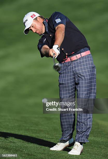 Graeme McDowell of Northern Ireland plays his approach shot on the second extra hole during the second round of the World Golf Championships -...