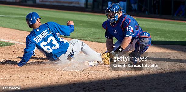 Kansas City Royals' Max Ramirez is tagged out at the plate by Texas Rangers catcher Konrad Schmidt in the ninth inning of a spring training game in...