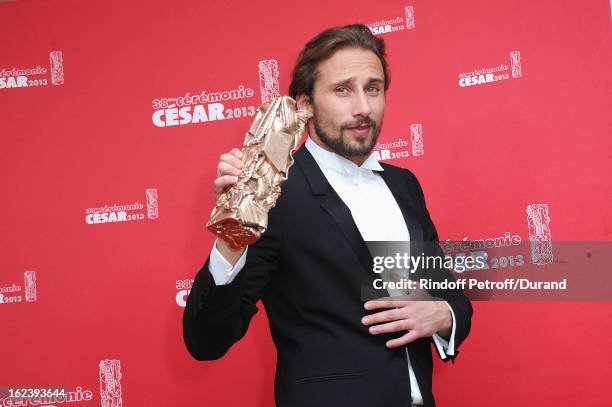 Matthias Schoenaerts poses with his trophy after receiving the Best Newcomer Actor award during the Cesar Film Awards 2013 at Theatre du Chatelet on...