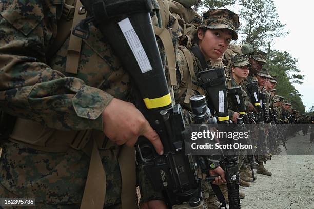 Marines, both male and female, pause for a water break during a 10 kilometer training march carrying 55 pound packs during Marine Combat Training on...