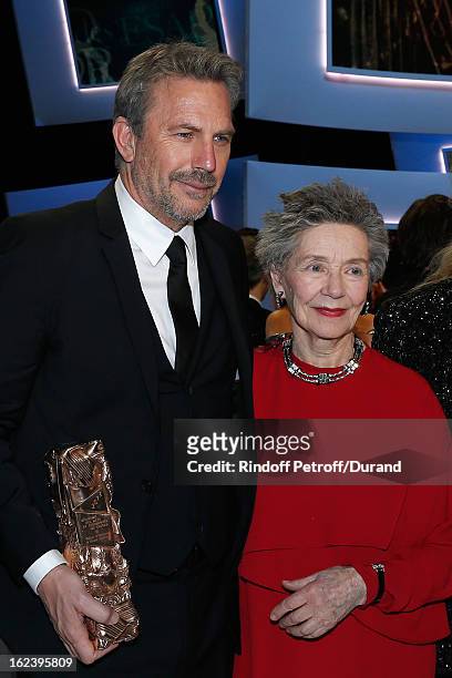 Kevin Costner, holding his Cesar of Honor award, and best actress Emmanuelle Riva for "Amour" pose on stage at the end of the Cesar Film Awards 2013...