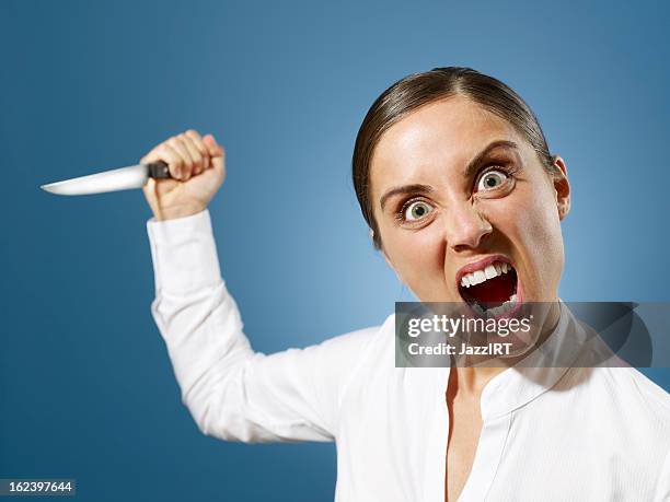 angry businesswoman with a knife - knife weapon stockfoto's en -beelden