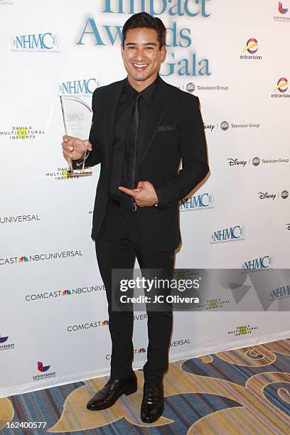 Actor Mario Lopez poses with his Outstanding Media Entrepreneur Award during the National Hispanic Media Coalition's 16th Annual Impact Awards Gala...