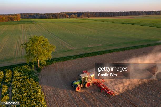 tractor kicking up dust in field - foods birds eye stock pictures, royalty-free photos & images