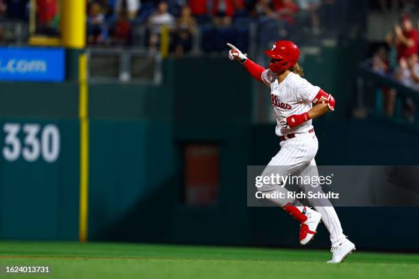 Alec Bohm of the Philadelphia Phillies gestures as he circles the bases after hitting a home run against the St. Louis Cardinals in the sixth inning...