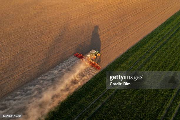 trattore che lavora sul campo, vista aerea - campo arato foto e immagini stock