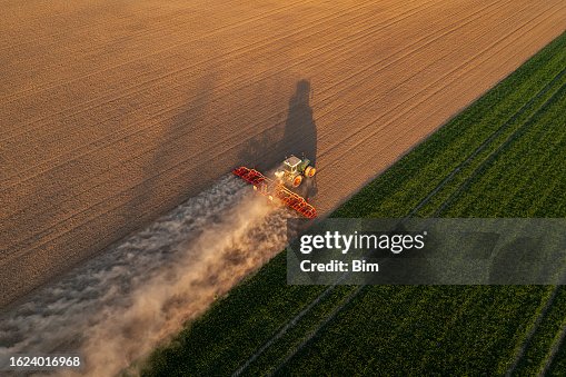 Tractor working in field, aerial view