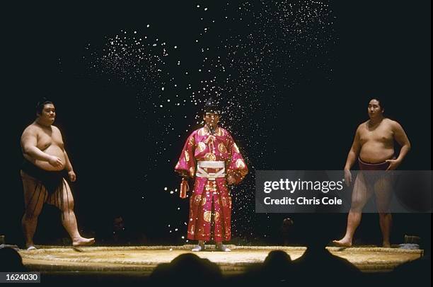 Two contestants participate in the salt throwing ceremony before the contest commences in the Grand Sumo Tournament at the Royal Albert Hall, London....