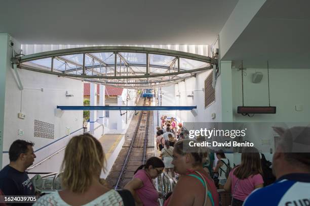 People wait in line to access the funicular and go up to the top on August 18, 2023 in Nazare, Portugal. Nazare receives a large number of tourists...