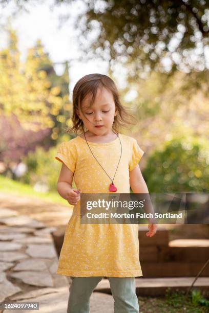 a child enjoying a beautiful park in barcelona, spain - pendants foto e immagini stock