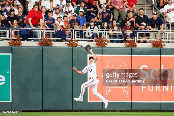 Matt Wallner of the Minnesota Twins jumps to catch a fly ball hit by Alfonso Rivas of the Pittsburgh Pirates in the second inning at Target Field on...