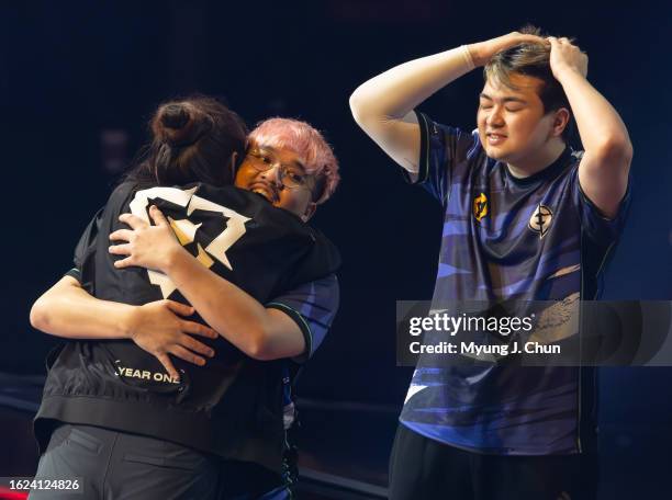 Evil Geniuses' Alexander "jawgemo" Mor, hugs coach Christine "potter" Chi after a hard-fought victory with his team including teammate Corbin "C0M"...