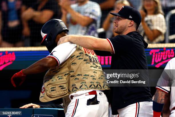 Ryan Jeffers of the Minnesota Twins puts a celebratory fishing vest on teammate Michael A. Taylor after Taylor hit a two-run home run against the...