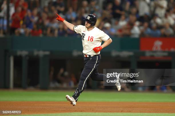 Mitch Garver of the Texas Rangers rounds the bases after hitting a solo home run against the Milwaukee Brewers in the fourth inning at Globe Life...