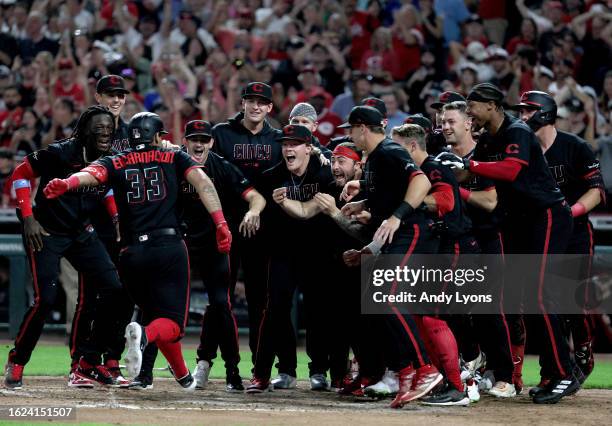 Christian Encarnacion-Strand of the Cincinnati Reds celebrates with teammates after hitting a game winning home run in the 9th inning against the...