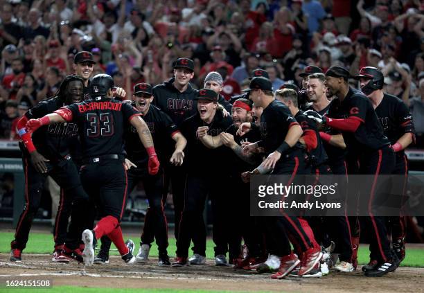 Christian Encarnacion-Strand of the Cincinnati Reds celebrates with teammates after hitting a game winning home run in the 9th inning against the...