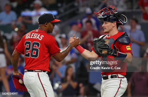 Raisel Iglesias and Sean Murphy of the Atlanta Braves celebrate their 4-0 win over the San Francisco Giants at Truist Park on August 18, 2023 in...