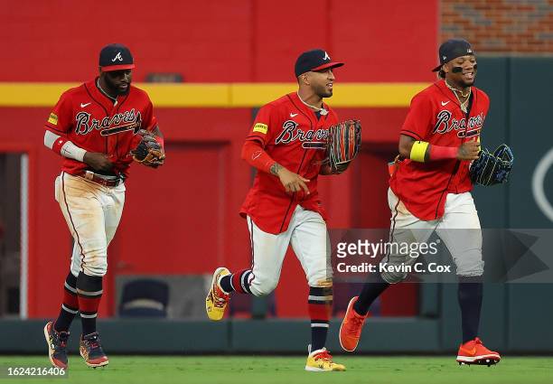 Ronald Acuna Jr. #13, Eddie Rosario and Michael Harris II of the Atlanta Braves react after their 4-0 win over the San Francisco Giants at Truist...