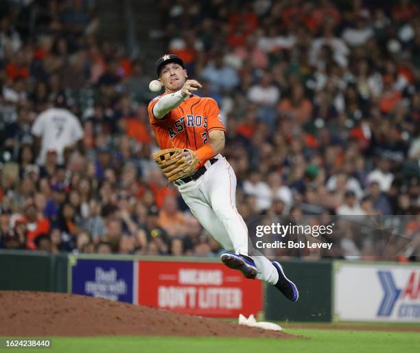 Alex Bregman of the Houston Astros throws to first base but is unable to retire Julio Rodriguez of the Seattle Mariners in the ninth inning at Minute...