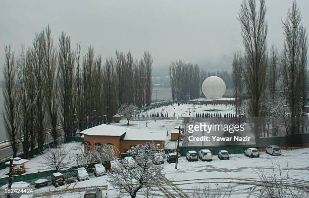 Hot air balloon is seen tied in a park after a snowfall on February 23, 2013 in Srinagar, Indian Administered Kashmir, India. Several parts of the...