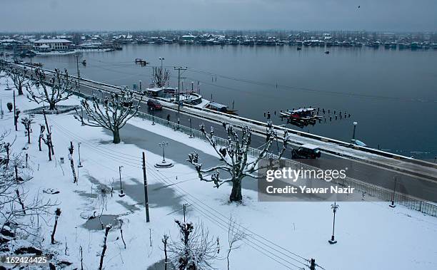 Boats are moored to the bank of Dal lake after a snowfall on February 23, 2013 in Srinagar, Indian Administered Kashmir, India. Several parts of the...