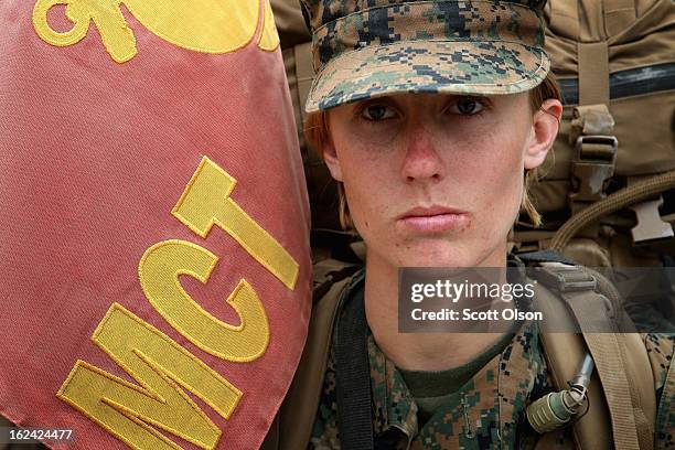 Pfc. Tiffany Mash of Torrance, California leads a company of Marines, both male and female, carrying 55 pound packs at the start of a 10 kilometer...