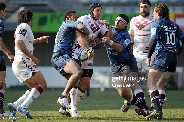 Bordeaux Begles' Lachie Munro vies with Montpellier's Maximiliano Bustos and Timoci Nagusa during the French Top 14 rugby Union match Montpellier vs...