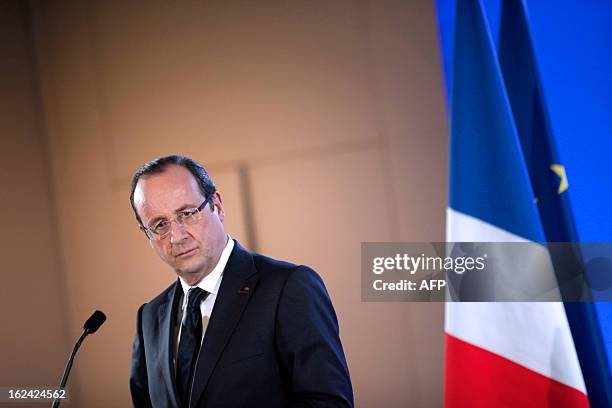 French President Francois Hollande looks on as he attends a press conference during the 50th International Agriculture Fair, at the Porte de...