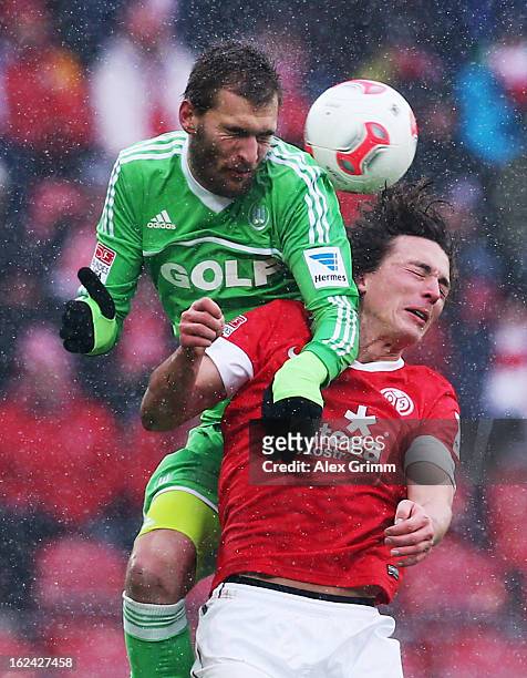 Julian Baumgartlinger of Mainz is challenged by Bas Dost of Wolfsburg during the Bundesliga match between 1. FSV Mainz 05 and VfL Wolfsburg at Coface...